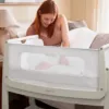 Mother interacting with baby in the SnuzPod 4 Bedside Crib