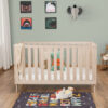 Front view of Babymore Dante Cot Bed in natural wood with playful decor and alphabet rug.