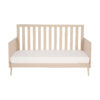 Front-facing studio image of Babymore Dante Cot Bed showcasing slatted sides and mattress.