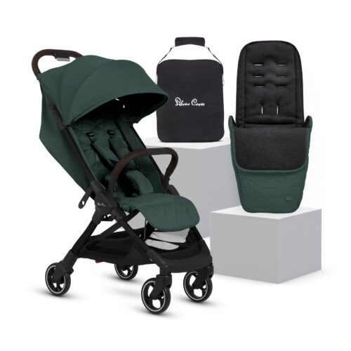 The Silver Cross Clic 2 Stroller in "Conifer," a deep green shade, displayed alongside a matching footmuff and a travel bag with the "Silver Cross" logo. The stroller features a quilted seat, an adjustable canopy, and a five-point harness. The footmuff, designed for warmth and comfort, is placed on a white pedestal.