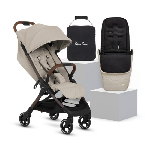 The Silver Cross Clic 2 Stroller in "Latte" color displayed alongside a matching footmuff and a travel bag with the "Silver Cross" logo. The stroller features a quilted seat, an adjustable canopy, and a five-point harness. The footmuff, designed for warmth and comfort, is displayed on a white pedestal.