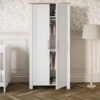Nursery room featuring the Silver Cross Valencia Wardrobe in White & Natural Ash with with one of the doors open.