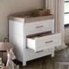 A Nursery featuring the Silver Cross Valencia Dresser in White & Natural Ash with one of the drawers open