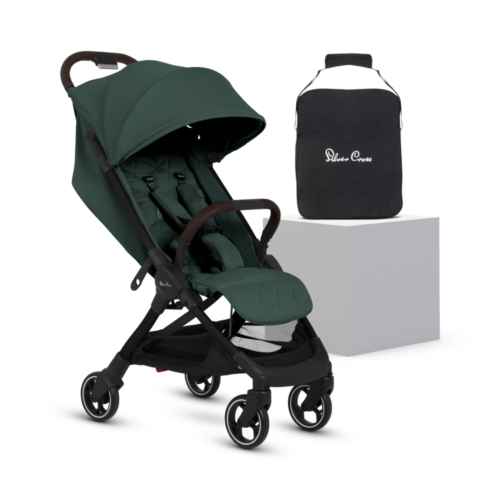 The "Conifer" stroller displayed next to its black travel bag on a white pedestal, showcasing its stylish and practical design.