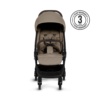 A front view of the stroller with its beige fabric, brown handlebar, and secure harness system. A 