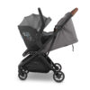 Grey infant car seat attached to a matching grey UPPAbaby stroller frame with brown handlebar.