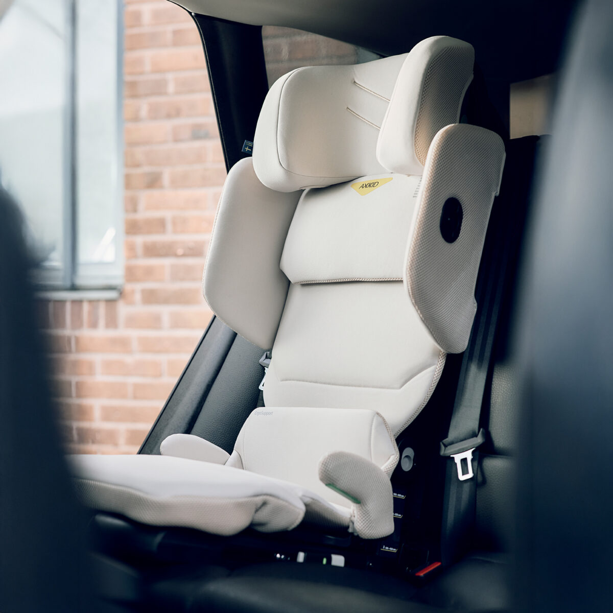 Side view of AXKID Up High Back Booster Car Seat showing seat padding and safety features