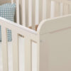 Close-up of cot bed corner in cashmere finish showing smooth build detail.