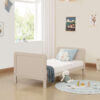 Toddler bed setup in cashmere with plush toys, pillow and soft natural light.