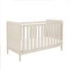 Angled side view of cashmere cot bed with clean lines and slatted rails.