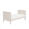 Toddler bed mode in cashmere shown at an angle with full mattress view.