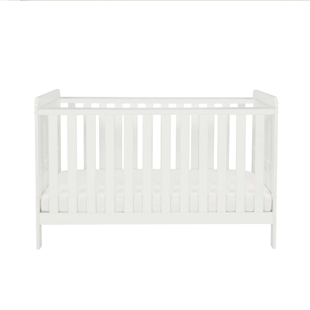 Straight front view of white cot bed with mattress against plain white backdrop.