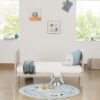Cashmere toddler bed in nursery with window, wall art and bunny plush toy.