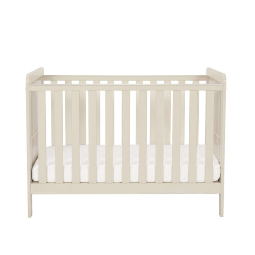 Front view of cashmere mini cot bed with white mattress against plain background.
