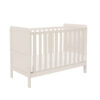 Angled view of cot bed in cashmere showing slatted sides and back panel.