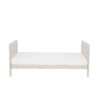 Side view of toddler bed in cashmere with minimal design and clean finish.