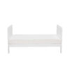 Side view of cot bed in toddler bed mode with clean lines and low profile.
