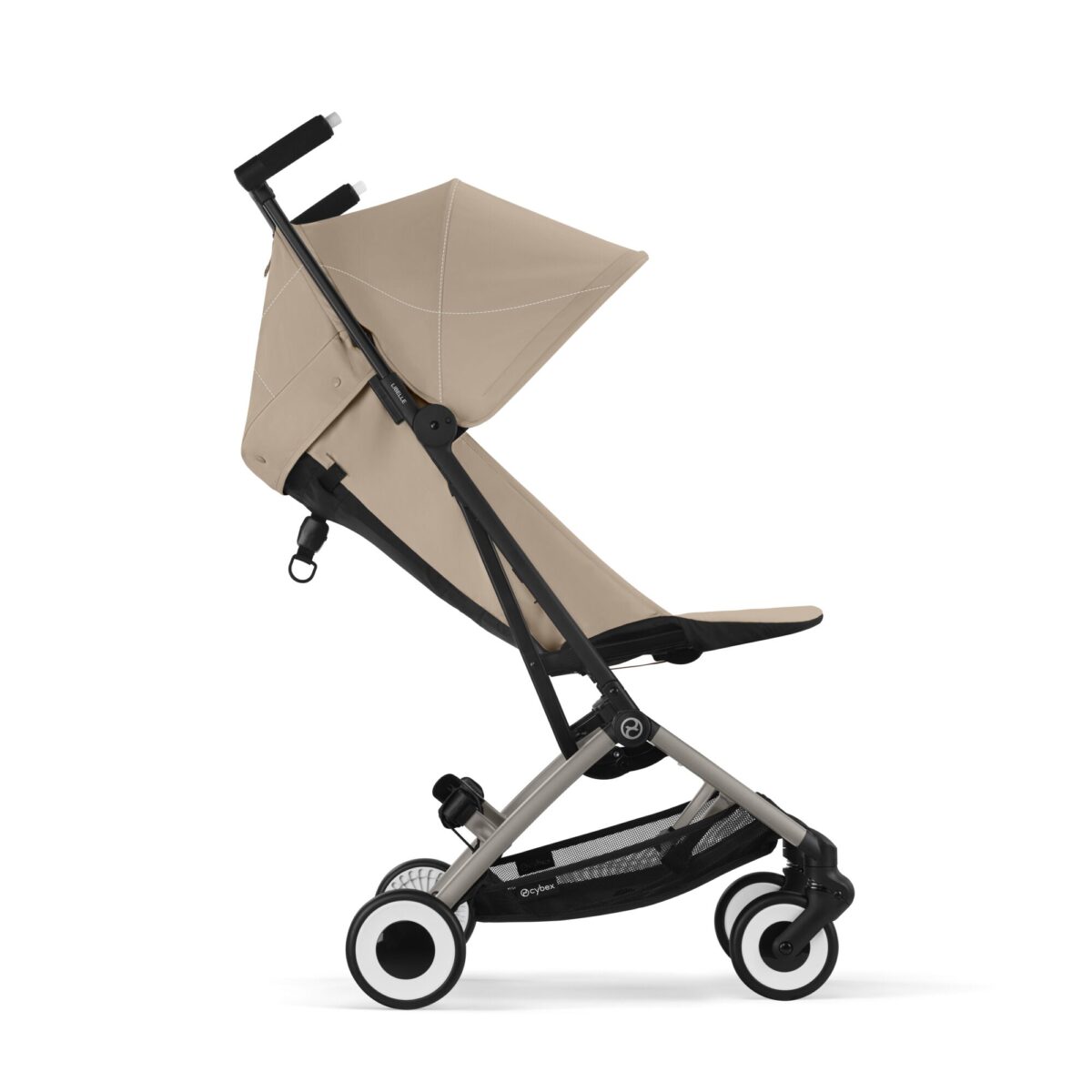 Side profile of Cybex Libelle stroller in Almond Beige in upright position with dual wheels and storage basket.