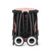 Folded Cybex Libelle stroller in Candy Pink showcasing ultra-compact, travel-friendly design and sturdy build.