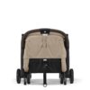 Back view of the Cybex Orfeo stroller in Almond Beige with a secured folding strap and reclined seat.