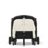 Back view of the Cybex Orfeo stroller in Canvas White with a secured folding strap and reclined seat.