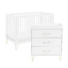 White crib and matching dresser set with gold legs, shown on a plain white background.