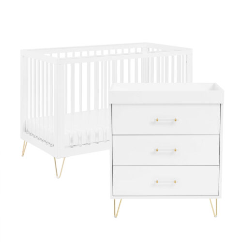 White crib and matching dresser set with gold legs, shown on a plain white background.