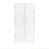 Front view of a closed white wardrobe with gold legs, on a plain white background.