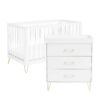 atching white crib and dresser with gold legs shown on a plain white background.