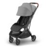Greyson UPPAbaby MINU V3 stroller angled view with canopy extended and brown leather handlebar.