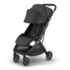 Jake UPPAbaby MINU V3 stroller angled view with canopy extended and brown leather handlebar.