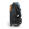Side view of the folded UPPAbaby MINU V3 stroller in Dillan, showing compact design and wheels.
