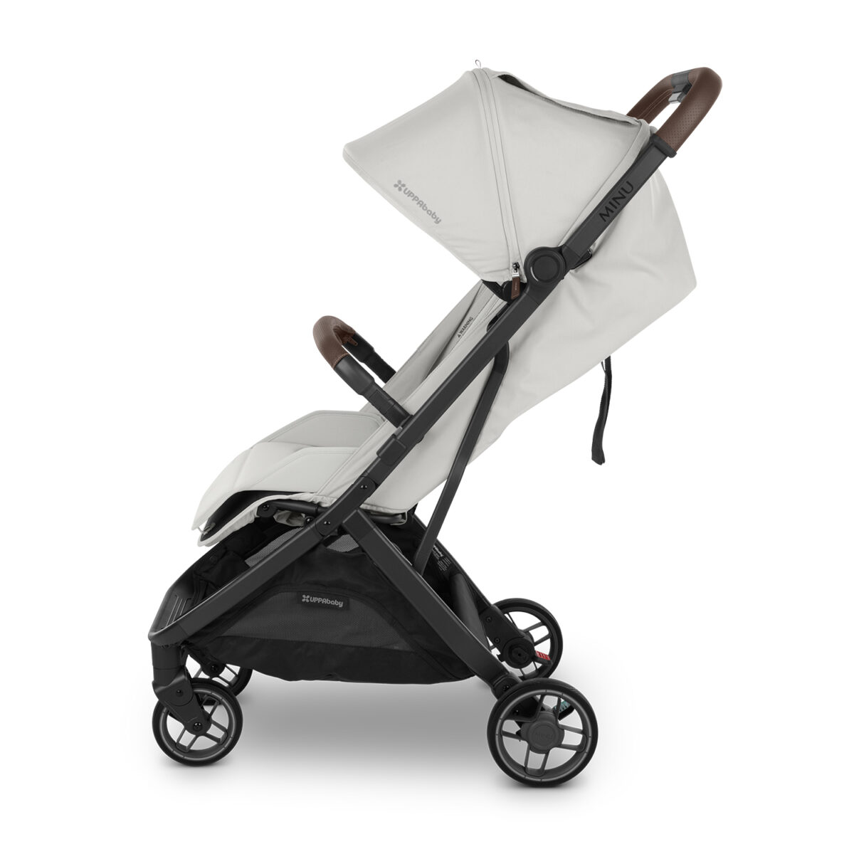 Side view of white UPPAbaby stroller with dark brown leather handlebar and bumper bar.