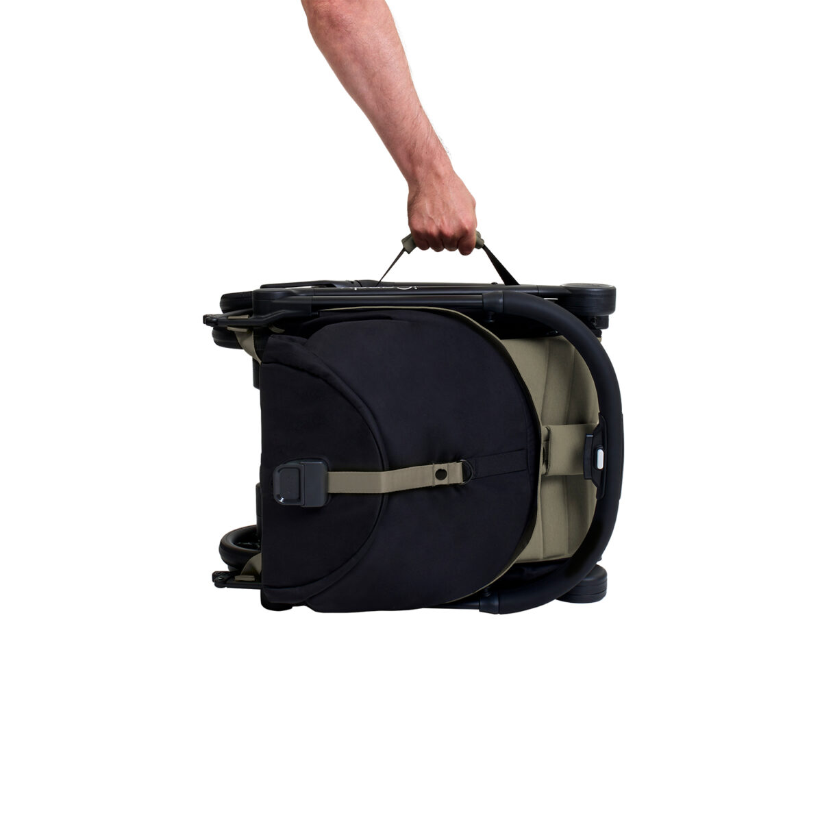Folded sage iCandy stroller being carried by handle with one hand.
