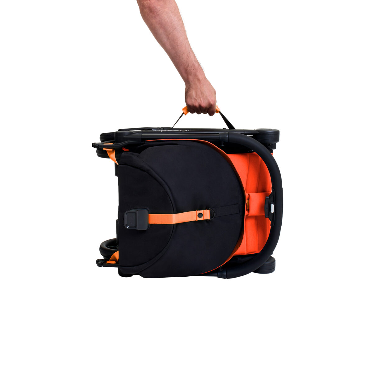 Folded sunset iCandy stroller being carried by handle with one hand.